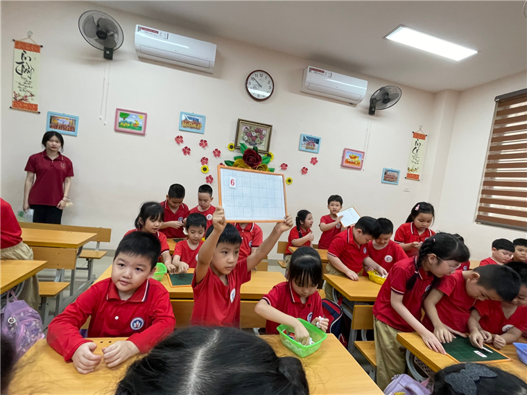 A group of children in a classroomDescription automatically generated
