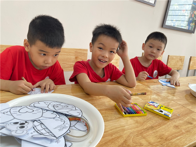 A group of boys sitting at a table coloringDescription automatically generated